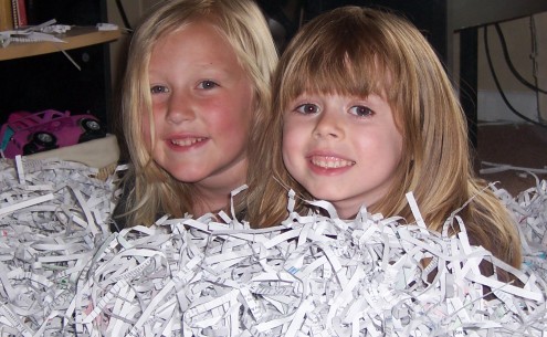 Girls Buried in Shredded Paper